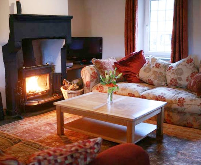 The House at Paradigm is a beautiful character-filled hideaway without compromising the luxury of the modern touch.
A stunning kitchen surrounds the simple warmth of the AGA range. With prior notice, we can prepare meals and leave them ready for your return at the end of your day so you need not worry about dining. It's the handy advantages that will most delight - the convenience of chilled Lakeland water and ice direct from the fridge dispenser.
The Honister Green Slate flagged floor leads through to the lounge and around the woodburner where the oak beams and sandstone add a sense of home. Here you can slump into the large, sumptuous sofas. Wander through the stone arch to the dining room; where as you dine; take in the view through the patio doors across the small valley towards the hamlet of Pardshaw.
As you go up the solid oak stairs to the two double rooms, you'll find one ensuite with two single beds or super king size. The other super king room has its own bathroom with Victorian rolltop bath.