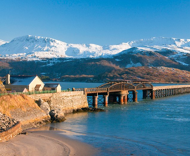 Situated in the heart of the Snowdonia National Park this 70 mile/113 km shorter section of the Wales Coast Path takes you from the harbour town of Porthmadog, with its maritime history, down to Cardigan Bay ending at Machynlleth in mid Wales. It is possible to link to Glyndŵr’s Way at Machynlleth.
A truly coastal section, especially from Harlech and its fine medieval castle, this walk takes in vast and expansive beaches, but also offers interesting coastal plains, some hilly sections and challenging woodland, where some of Snowdonia’s finest peaks come into view. The walk ends at the historic market town of Machynlleth.