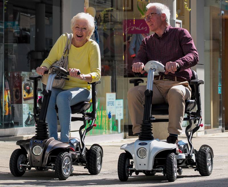 The Maximo is a mid-sized folding scooter based on the best-selling smaller TGA Minimo. Despite its larger size, the Maximo is ideal for travel on buses, trains or in the car and can be folded in seconds. It has a fully adjustable tiller and orthopaedic seat for personalised comfort so owners can relax their shoulders, arms and hands when driving.
The spacious floor-well allows drivers to stretch out their legs and the active rear suspension provides a smooth ride when driving across grass or gravel. The Maximo combines advanced transportability with the ability to tackle rougher terrain – perfect for stately homes, woodland walks and coastal paths.