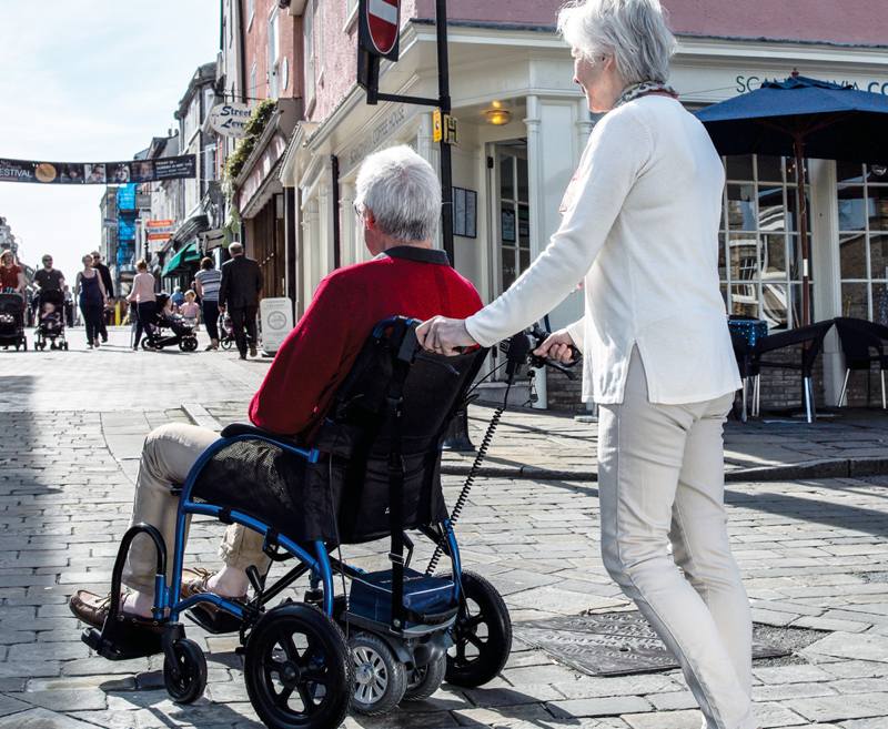 The TGA Powerpack is first choice for healthcare professionals and consumers looking for the best solution to help propel a manual attendant-controlled wheelchair.
The four Powerpack models from TGA have delivered trustworthy mobility assistance for over 20 years. They encompass cutting edge engineering and ergonomic design which deliver outstanding power, traction and reliability – ideal for visiting picturesque AONB. They will drive almost all types of wheelchair, including many tilt-in-space models and eliminate the difficulties posed for all carers when negotiating slopes and uneven surfaces.
Fast to fit and pack away for transit, TGA Powerpacks are the ideal partner for the TGA Strongback wheelchair which is foldable and lightweight. Together they are the perfect solution for carers and wheelchair users to enjoy the countryside strain-free.