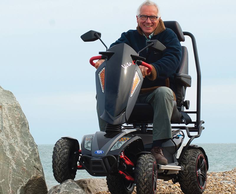 The Vita X is a robust and reliable 8mph scooter built for off-road terrain. This striking scooter has cutting-edge looks ideal for style-conscious people seeking the thrill of countryside independence.
With advanced and independent motorcycle suspension the Vita X is able to tackle challenging routes with ease. Add to this specialist high grip tyres, powerful motor and controller and bucket leather seat, Vita owners weighing up to 28 stone have the capability to adventure outdoors with stability and safety. The Vita X comes with high visibility LED lighting and is only available in sporty black and red.