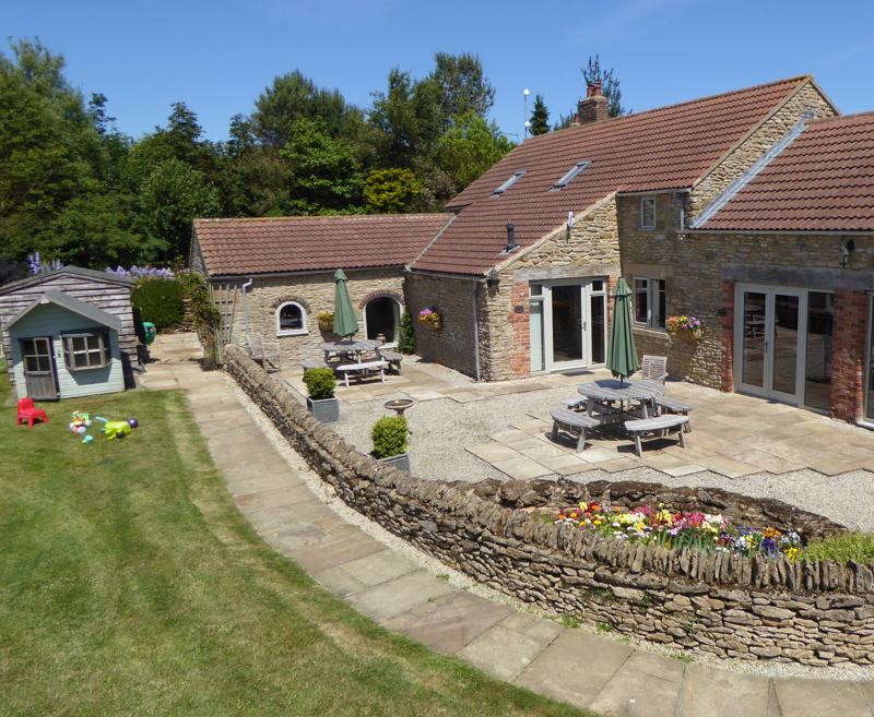 Vale Cottage has real wow factor with double height lounge, huge windows and oak beams.  Planned for people who have mobility problems and need a wheelchair some of the time.  The space is generous, the doors  wide and the floors level.  There is a gentle slope from the car park and low threshold.
The large ground floor bedroom can be a super king or twin beds.  There is a door through to the wet room which has room for a helper. 
The lounge is spacious with an open plan staircase to the mezzanine with twin beds.
The kitchen is easily accessed through an archway.
Vale and Meadow cottages can be booked together.