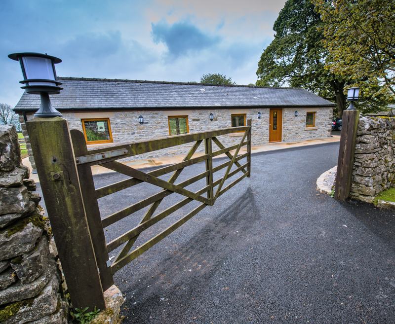 The cottage has two bedrooms – one double with en suite shower room, and a twin with profiling bed and electric tilting bed with optional guard rail & bed raisers.
This room has large wet room beside it with a comfort height toilet, grab rails, wheelchair accessible basin and shower with fixed and hand held heads, self-propelling shower chair and non-slip flooring.
Both bedrooms have wide doors off the lounge area, televisions and ample storage space.
The single bedroom has an escape door to the rear patio which is fully integrated with the alarm system.