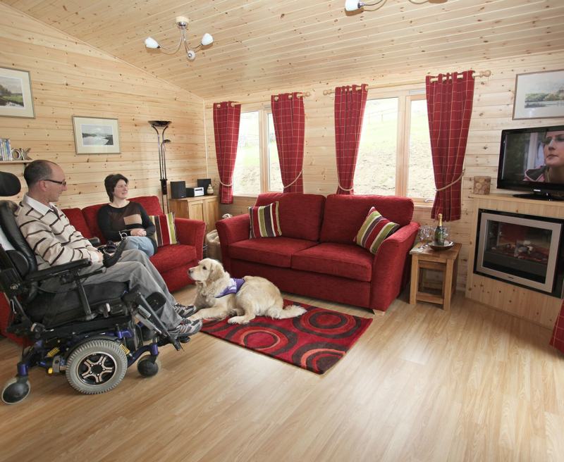 With all the comforts of home and a wide range of specialist equipment you can relax in our peaceful surroundings and take time out to watch the wildlife. For the more adventurous why not hire the Boma 7 off-road wheelchair to explore local trails?

Sleeping up to four guests each lodge has an accessible wheel in shower room and a luxurious family bathroom. There is plenty of space for wheelchair users, and the log cabins are dog friendly with some wonderful walks from the door. 

Owners David and Felicity Brown live on site and are on hand to help.