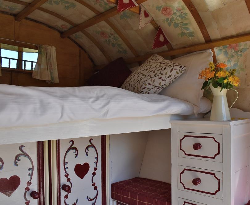 Rose Hip Gypsy Caravan is an idyllic, romantic hideaway just for two; relax and cook by the firepit under the stars. Under the traditional bow top canvas there is a slide out double bed to climb into, bench seating and storage cupboards. 

Steeped in history our gorgeous gypsy caravan takes glamping to the next level with modern additions, including 12volt lighting, USB charging and WiFi. Bedding and towels included and a modern shower room just a few yards away.