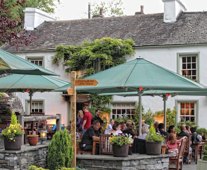 An ancient inn lost in blissful countryside near Lake Windermere, The Masons Arms is a Lakeland Institution.
With its traditional bar, wavy floors, beamed ceilings and roaring fire, The Masons offers a warm welcome to walkers after a long day in the fells. You’ll find an elegant dining room upstairs, two cottages and five suites if you fancy staying longer, plus a terrace with views spanning 15 miles across a quilt of fields – in some of the finest scenery in the southern Lakes.
Hearty Cumbrian fayre from a locally-sourced menu is perfectly partnered with hand-pulled ales and a carefully curated wine list, all welcome refreshment after exploring England’s finest mountain scenery.
[symple_button url=