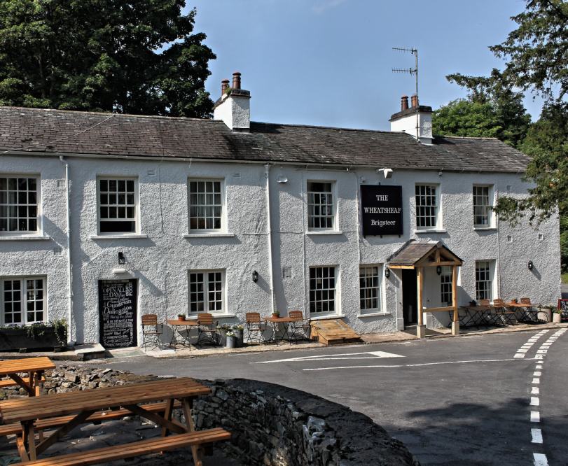 Based in the beautiful village of Brigsteer in the Lake District National Park, the multi award-winning Wheatsheaf Inn is perfect for families, walkers, cyclists and dog owners.

At the foot of the peak of Scout Scar and surrounded by beautiful views across the Lyth Valley, this historic inn (dating back to 1762) has six cosy bedrooms and serves real ale and home-cooked food.

[symple_column size=