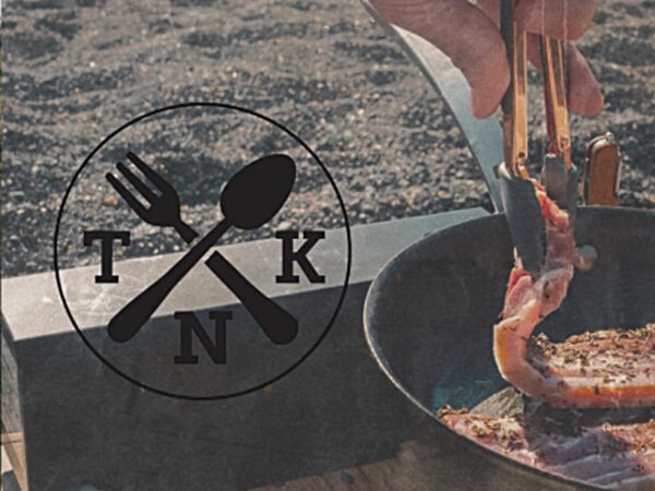 The Nomad's Kitchen Outdoor cooking and camping Stove, sizzling bacon in a pan.