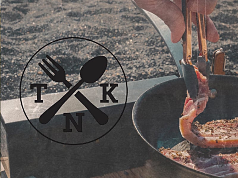 The Nomad's Kitchen Outdoor cooking and camping Stove, sizzling bacon in a pan.