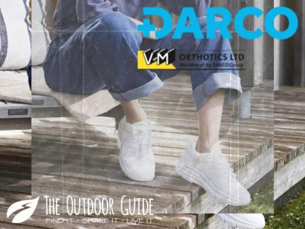 A woman sits on a step in stylish orthopedic shoes