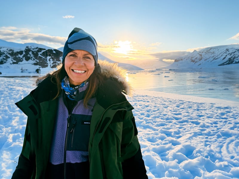 Julia Bradbury in Antarctica. Stood on an ice sheet with the sun glowing behind her, Wonders of the Frozen South ITV Episode 3